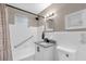 This bathroom has a shower and tub combo with white tile and granite vanity at 461 Brentwood Dr, Daytona Beach, FL 32117