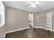 This is a light and airy bedroom with wood floors, ceiling fan and an open closet at 461 Brentwood Dr, Daytona Beach, FL 32117
