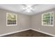 Well-lit bedroom with wood-look floors and two windows for abundant natural light at 461 Brentwood Dr, Daytona Beach, FL 32117