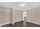 This bedroom has wood floors and neutral paint with an open closet at 461 Brentwood Dr, Daytona Beach, FL 32117