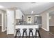 Well-appointed kitchen with white cabinetry, granite countertops, and bar stool seating at 461 Brentwood Dr, Daytona Beach, FL 32117