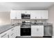 Updated kitchen with white cabinets, granite countertops, and stainless steel appliances at 461 Brentwood Dr, Daytona Beach, FL 32117