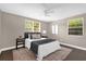 Serene main bedroom with a ceiling fan, two windows, and dark wood-look flooring at 461 Brentwood Dr, Daytona Beach, FL 32117