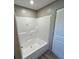 Bathroom showcasing a clean white shower and a doorway to the side at 4720 Oak St, Fruitland Park, FL 34731