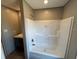 Bathroom view showcasing tub with shower features and fixtures at 4720 Oak St, Fruitland Park, FL 34731
