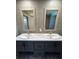 Bathroom double sink vanity with white countertops and matching framed mirrors at 4720 Oak St, Fruitland Park, FL 34731