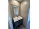 Modern bathroom features a vanity with gray cabinets and a framed mirror at 4720 Oak St, Fruitland Park, FL 34731