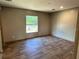 Bright bedroom featuring wood-look floors and a window providing natural light at 4720 Oak St, Fruitland Park, FL 34731