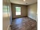 Cozy bedroom with wood-look floors and a window that provide ample natural light at 4720 Oak St, Fruitland Park, FL 34731