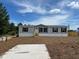 Charming single-story home with an unfinished front yard and concrete driveway at 4720 Oak St, Fruitland Park, FL 34731