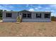 Charming single-story home featuring a neutral color scheme and black window shutters at 4720 Oak St, Fruitland Park, FL 34731