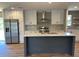 Modern kitchen featuring an island, stainless steel appliances, and white cabinetry at 4720 Oak St, Fruitland Park, FL 34731