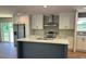 Modern kitchen featuring an island, stainless steel appliances, and white cabinetry at 4720 Oak St, Fruitland Park, FL 34731