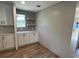 Modern kitchen with open shelving and white cabinets with stylish black hardware at 4720 Oak St, Fruitland Park, FL 34731