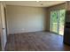 Spacious living room with wood-look flooring and sliding glass doors leading to a deck at 4720 Oak St, Fruitland Park, FL 34731