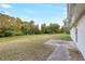 Expansive backyard featuring lush lawn and mature trees with natural Florida landscaping at 520 Eagle Cir, Casselberry, FL 32707