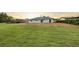 Large backyard with expansive lawn and a view of the home's exterior at 520 Eagle Cir, Casselberry, FL 32707