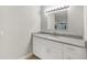 Bathroom vanity with granite countertop, white cabinets, and modern fixtures at 520 Eagle Cir, Casselberry, FL 32707