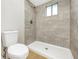Bathroom with glass enclosed shower featuring modern tile work and wood look flooring at 520 Eagle Cir, Casselberry, FL 32707