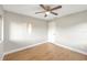 Neutral bedroom with ceiling fan, wood floors, and ample natural light at 520 Eagle Cir, Casselberry, FL 32707