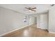 Bedroom featuring a mirrored closet, ceiling fan and wood-look flooring at 520 Eagle Cir, Casselberry, FL 32707