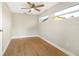 Bright bedroom featuring hardwood floors, neutral walls, and natural light from two windows at 520 Eagle Cir, Casselberry, FL 32707