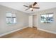 Bright bedroom featuring updated ceiling fan, wood floors and ample light at 520 Eagle Cir, Casselberry, FL 32707