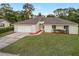 Charming single-story home featuring a two-car garage, well-maintained lawn, and inviting front entrance at 520 Eagle Cir, Casselberry, FL 32707