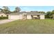Welcoming one-story home with lush front lawn, two-car garage, and classic architectural details at 520 Eagle Cir, Casselberry, FL 32707