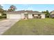 Lovely one-story home featuring a two-car garage, lush lawn, and welcoming front entrance at 520 Eagle Cir, Casselberry, FL 32707