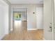 Inviting foyer with light-colored hardwood flooring leading to an open floor plan and sliding glass doors with a view at 520 Eagle Cir, Casselberry, FL 32707