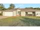 Charming single-story home featuring a well-manicured lawn, driveway, attached garage, and inviting front entrance at 520 Eagle Cir, Casselberry, FL 32707