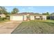 Charming single-story home featuring a well-manicured lawn, driveway, attached garage, and inviting front entrance at 520 Eagle Cir, Casselberry, FL 32707
