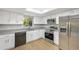 Well-lit kitchen boasts stainless steel appliances and white cabinets at 520 Eagle Cir, Casselberry, FL 32707