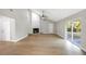 Bright living room features wood floors, a stone fireplace, and sliding glass doors that provide plenty of natural light at 520 Eagle Cir, Casselberry, FL 32707