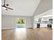 Open-concept living area flows to a kitchen featuring white cabinets, stainless steel appliances, and a sliding glass door at 520 Eagle Cir, Casselberry, FL 32707