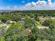 Aerial view of residential area with mature trees and single Gathering homes under a bright blue sky with some clouds at 525 Garden Heights Dr, Winter Garden, FL 34787