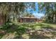 Expansive backyard featuring mature trees and a serene view of the property at 525 Garden Heights Dr, Winter Garden, FL 34787