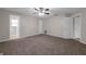 Bedroom with plush carpet, a ceiling fan, and closets for storage and access to the en suite bath at 525 Garden Heights Dr, Winter Garden, FL 34787