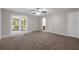 Bedroom showcasing neutral walls and brown carpeting with a ceiling fan and sliding door to the outside at 525 Garden Heights Dr, Winter Garden, FL 34787