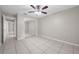 Bedroom with tile floors, ceiling fan, and sliding mirrored closet at 525 Garden Heights Dr, Winter Garden, FL 34787