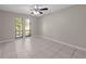 Bedroom with neutral walls, tile flooring, and a bright window at 525 Garden Heights Dr, Winter Garden, FL 34787