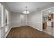 Dining room featuring wood floors, wainscoting, and a view into the kitchen at 525 Garden Heights Dr, Winter Garden, FL 34787