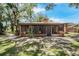 Rear exterior view of the home with a screened-in porch and large backyard at 525 Garden Heights Dr, Winter Garden, FL 34787