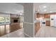 Kitchen view highlighting the stone fireplace and hardwood floors in the adjacent living area at 525 Garden Heights Dr, Winter Garden, FL 34787