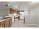 Functional kitchen with wooden cabinets, tile flooring, and bright white appliances at 525 Garden Heights Dr, Winter Garden, FL 34787