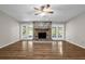 Bright living room featuring hardwood floors, a stone fireplace, and french doors at 525 Garden Heights Dr, Winter Garden, FL 34787