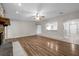 Open living room with a stone fireplace, hardwood floors, and abundant natural light at 525 Garden Heights Dr, Winter Garden, FL 34787