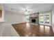Bright living room features a stone fireplace, ceiling fan, wood-look flooring, and French doors to the exterior at 525 Garden Heights Dr, Winter Garden, FL 34787