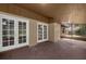 Covered patio with brick flooring and french doors, perfect for entertaining at 525 Garden Heights Dr, Winter Garden, FL 34787